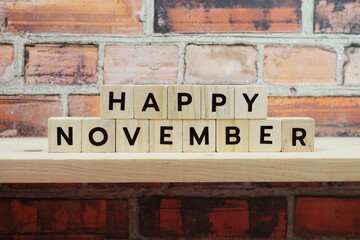 Happy November alphabet letter on shelves wooden background