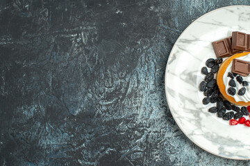 top view little delicious cake with chocolate and raisins on light-dark background cake sweet biscuit sugar dessert free place
