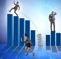 Business people jumping over bar charts