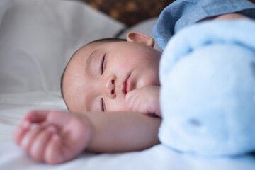 The Sleeping cute New Born Baby infant on the bed