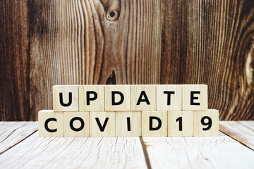 Update Covid-19 alphabet letter on wooden background