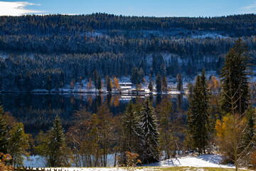 Titisee-Neustadt, Germany - 10 30 2012: surroundings of Titisee, european village, Black forest in beautiful winter cold day. Scenery is reflected in the lake. 