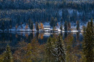 Titisee-Neustadt, Germany - 10 30 2012: surroundings of Titisee, european village, Black forest in beautiful winter cold day. Scenery is reflected in the lake. 