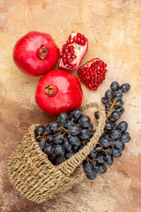 top view fresh black grapes with pomegranates on light background ripe fruit mellow photo tree vitamine