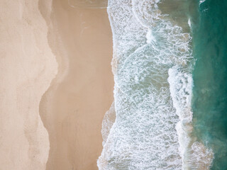 Fototapeta na wymiar Aerial drone photo of beach in Australia with Pacific Ocean waves crashing in and golden sand beaches with blue water