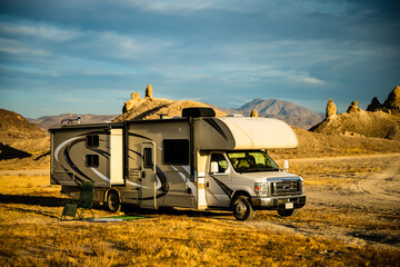 RV camper alone by desert rocks