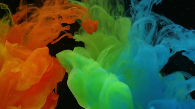 RGB Liquid Ink Splash in Water. Colorful Abstract Background close up. Black background. Amazing waves pattern  of red, green and blue colors