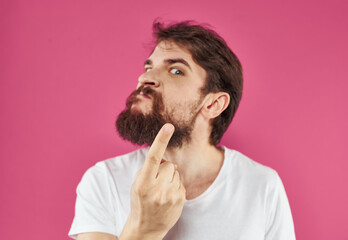 Fototapeta premium Man on pink background stress irritability aggression gesticulating with hands cropped view