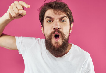 Man on pink background stress irritability aggression gesticulating with hands cropped view