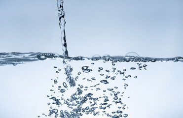 Water splash Aqua flowing in waves and creating bubbles Drops on the water surface feel fresh and...