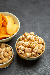 front view tasty cheese cips with different snacks on the dark background nut movie cinema photo potato food