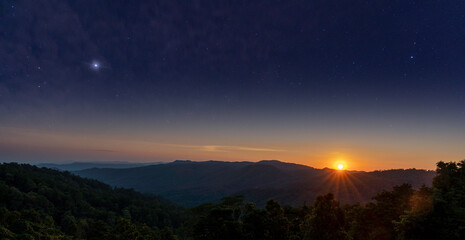 Fototapeta premium Double Exposure, Blue Sky, Star, Cloud. (Astronomy, Atmosphere, Science) with Twilight time, Sunset on the mountain Doi Khun Tan, Lampang, Northern, Thailand.