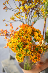 Set of yellow nd orange flowers for Interior decorations. The work of the florist at a flower shop. Fresh cut flower. European floral shop. Delivery fresh cut flower