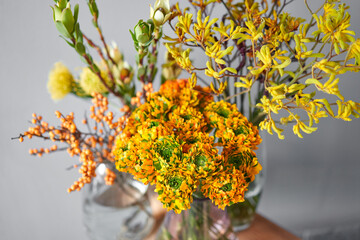 Set of yellow nd orange flowers for Interior decorations. The work of the florist at a flower shop....