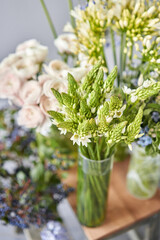 Set of white and blue flowers for Interior decorations. The work of the florist at a flower shop. Fresh cut flower. European floral shop. Delivery fresh cut flower