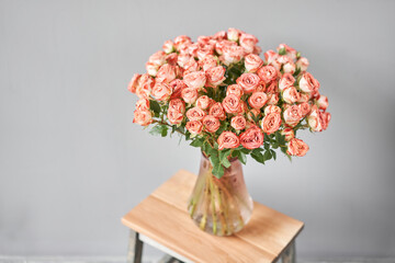 pink rose branch in a vase . Summer background. Bouquet of roses present for Mothers Day. Photo of Flowers for a catalog of flower online store and delivery.