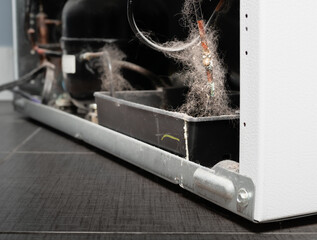 Dirty fridge copper pipe with corrosion and white efflorescence, perspective view. Backside of...