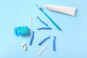 Fototapeta premium Toothbrushes for dental braces, floss and paste on color background