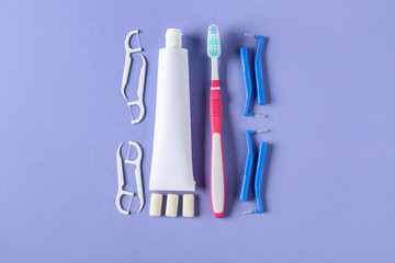 Toothbrushes for dental braces, floss and paste on color background