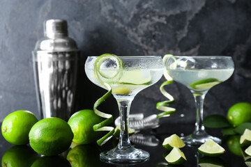 Glasses of fresh martini on dark background