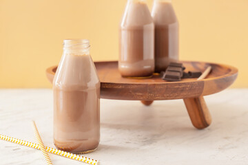 Bottle of tasty chocolate milk on table