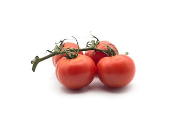Closeup of fresh tomatoes on branch on white background