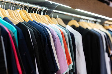 Close up view of stand with various clothes in clothing boutique