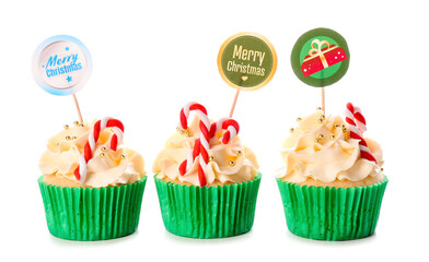 Tasty Christmas cupcakes on white background