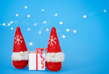 Christmas background. gnomes, gift, lights, garland. Copy space