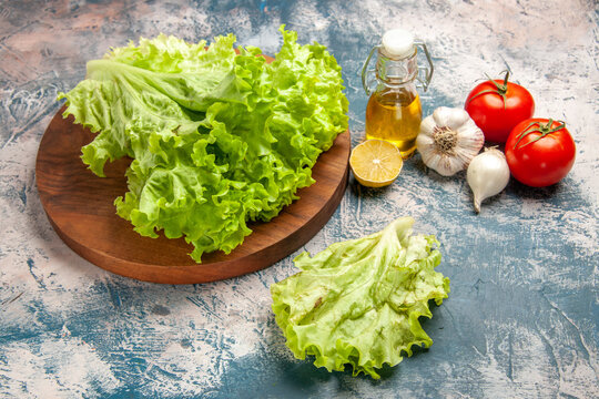 front view fresh green salad with garlic on light-blue background color photo ripe meal salad