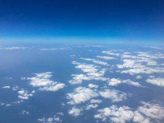 Naklejka na ściany i meble Top view sky and clouds looking from window airplane, nature background concept