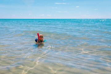 happy cute girl play with water gun on beach