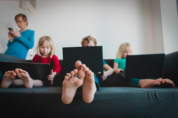 family staying home, kids looking at computers with father work with mobile phone - 400940829