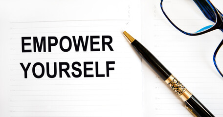 In the diary, the text of Empower Yourself, next to the pen, glasses.