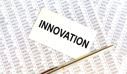 Fototapeta premium On the card with the text OF INNOVATION, next to the pen, reports.