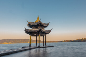 Naklejka premium Sunrise view of Jixian pavilion, the landmark at the west lake in Hangzhou, China.