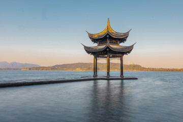 Fototapeta premium Sunrise view of Jixian pavilion, the landmark at the west lake in Hangzhou, China.