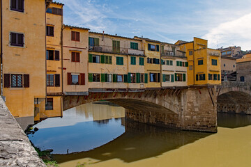 Fototapeta na wymiar The Ponte Vecchio Bridge over the Arno River at the old town of Florence, Tuscany Region in Italy 