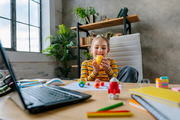 Girl using laptop to study online planets of Solar system