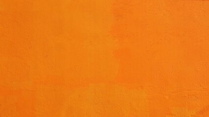 Bright orange cement wall. Vintage orange painted texture or background wall for full frame...