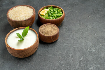 top view bowls with rice natural yogurt parsley pepper on dark background with copy space