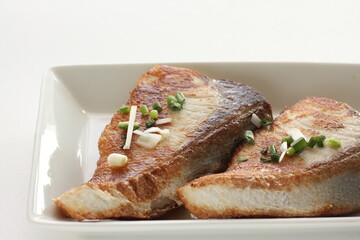 Asiian food, fried yellowtail fillet on dish with copy space