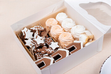 Christmas gift box with gingerbreads and marshmallows. Holiday sweets