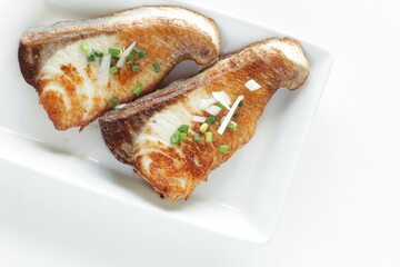 Asiian food, fried yellowtail fillet on dish with copy space