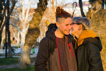 Gay lesbian couple portrait, two adult woman in the park, smiling and hugging