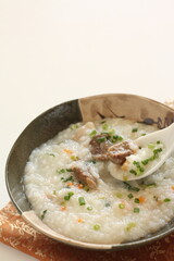 Chinese food, meat and congee with green onion and carrot
