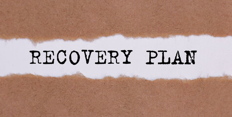 Recovery plan word written behind torn paper. business