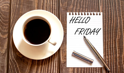 HELLO FRIDAY - white paper with pen and coffee on wooden background