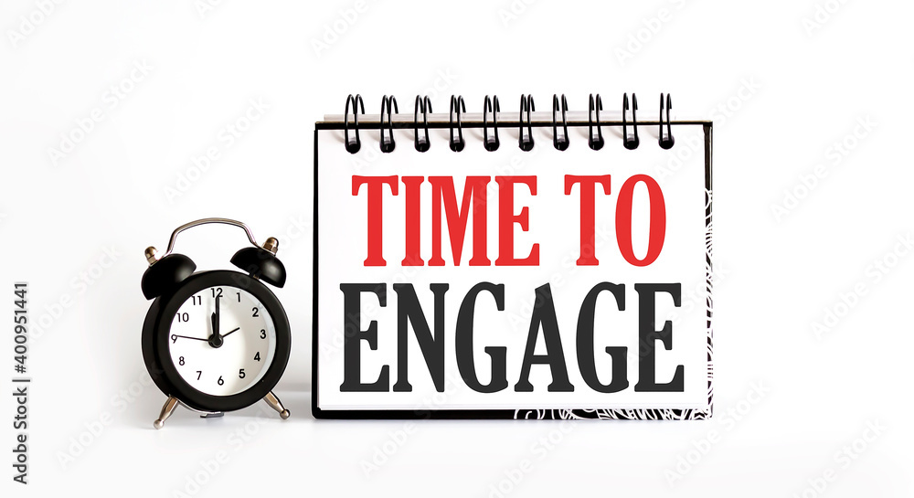 Poster time to engage notepad writing on the white background with alarm clock