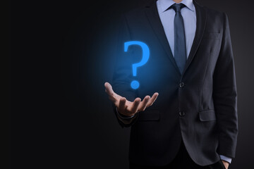 Businessman man hand hold interface question marks sign web. Ask quiestion online, FAQ concept, what where when how and why, search information on internet